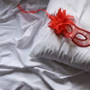 Red mask on a bed