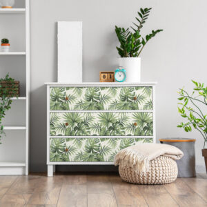 Chest of drawers and pouf with soft blanket in interior of light